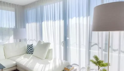 Bright-living-room-with-white-sheer-curtains-a-white-sectional-sofa-and-modern-decor