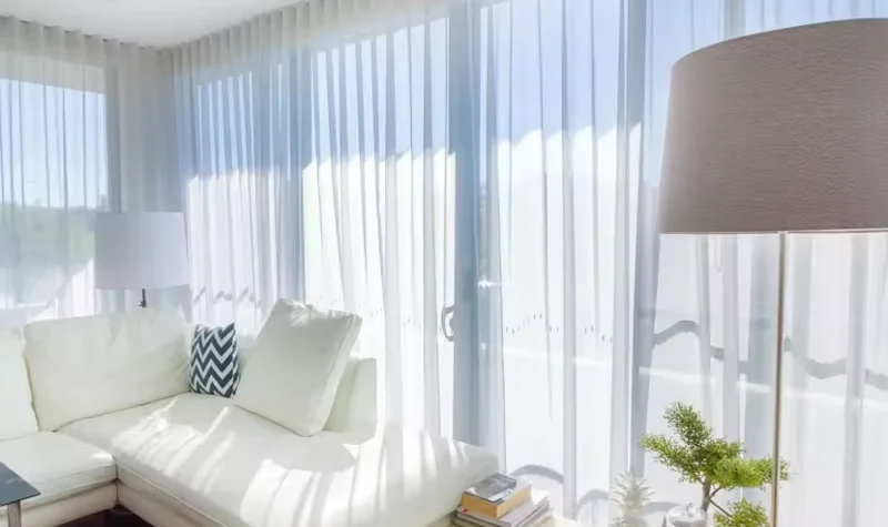Bright-living-room-with-white-sheer-curtains-a-white-sectional-sofa-and-modern-decor